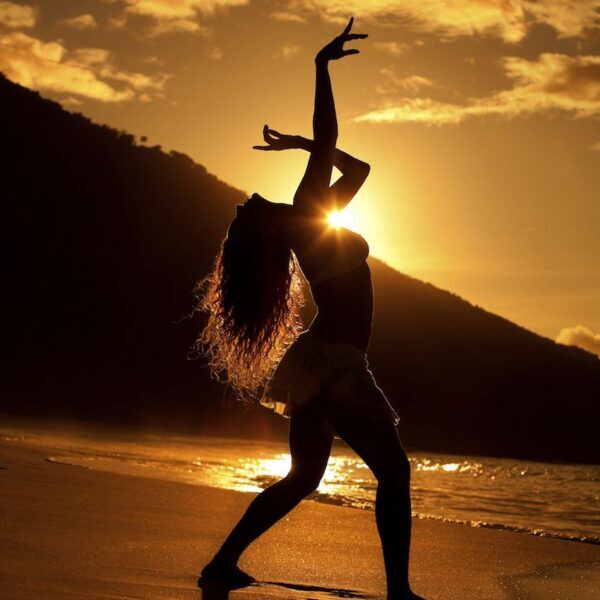 Silhouette of a woman on beach illustrating spiritual dance