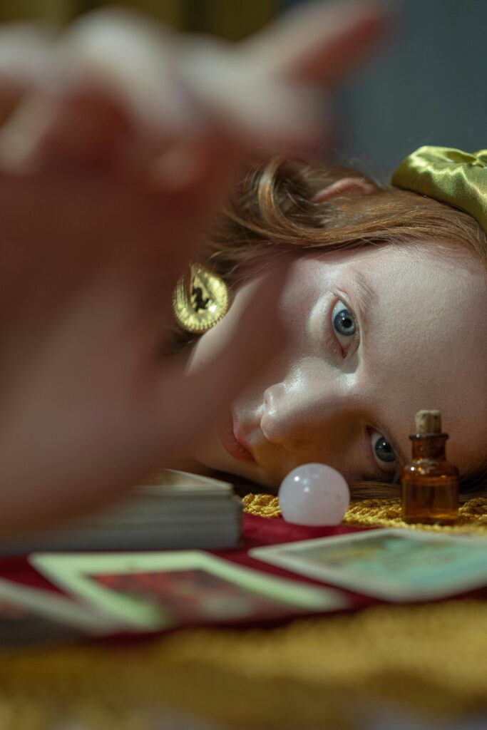 false light, picture of red hair woman laying on the floor staring into the camera with blue eyes