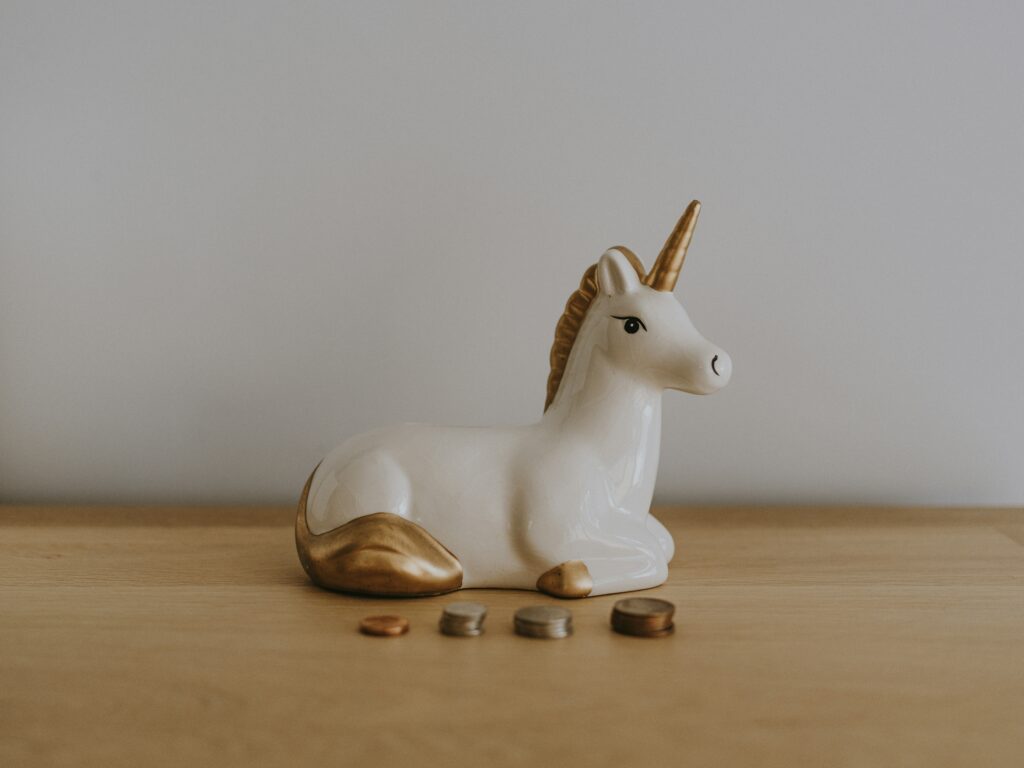 picture of unicorn  and coins representing money affirmations
