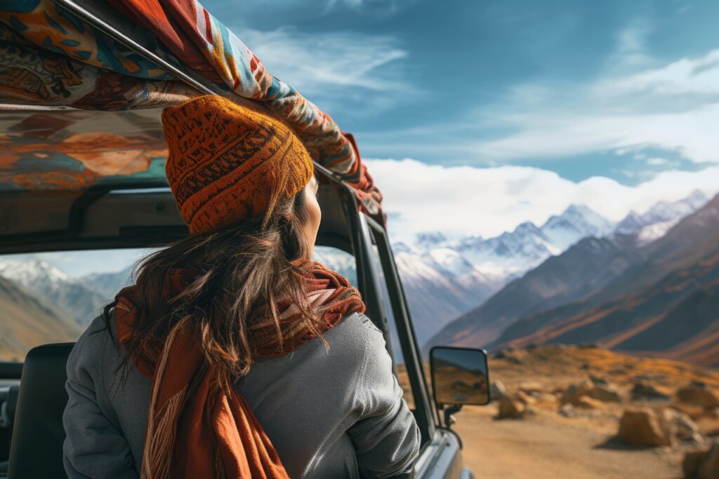 woman in car travelling in the himalayan mountain representing higher and travel