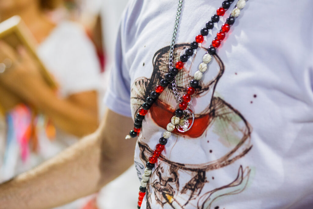 white shirt with a trickster design and red and white umband guides during carnival in Rio de Janeiro, Brazil representing umbanda
