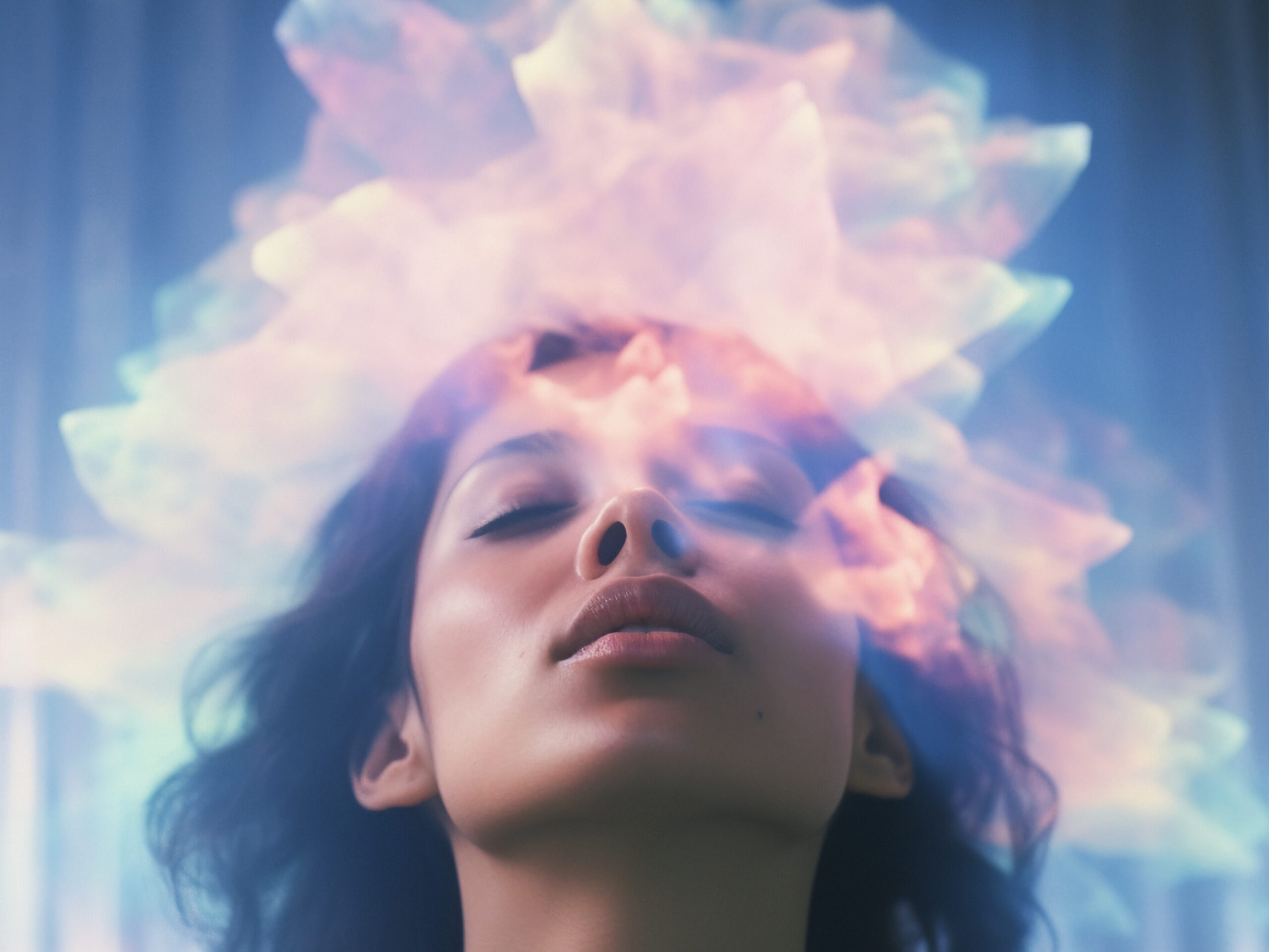 Portrait of a woman with her eyes closed and a colorful, ethereal light emanating from her head, symbolizing spiritual awakening and enlightenment