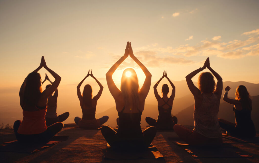 Group of people practicing yoga at sunset, embodying yoga philosophy love, with a focus on self-love and happiness, inspired by yoga quotes on happiness