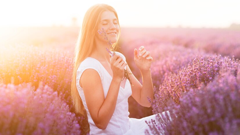 woman looking happy and peaceful and in a field of lavender