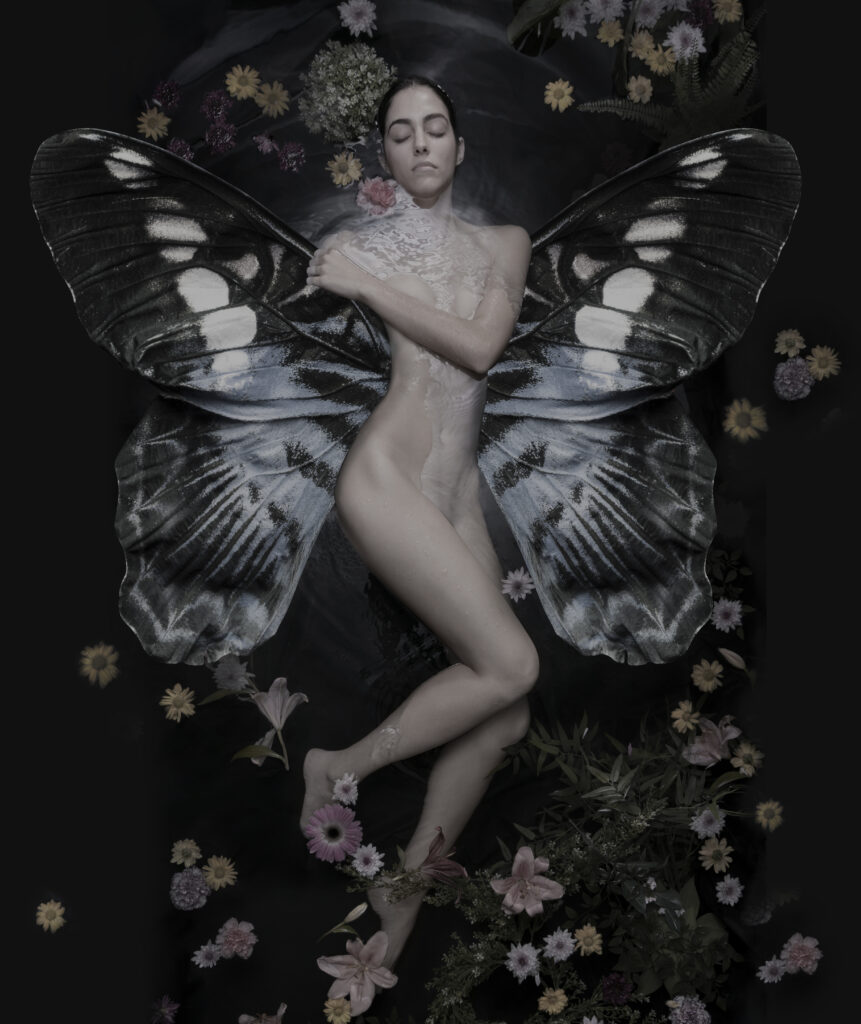 image of a naked woman with butterfly wings surrounded by water in flowers representing the dark feminine