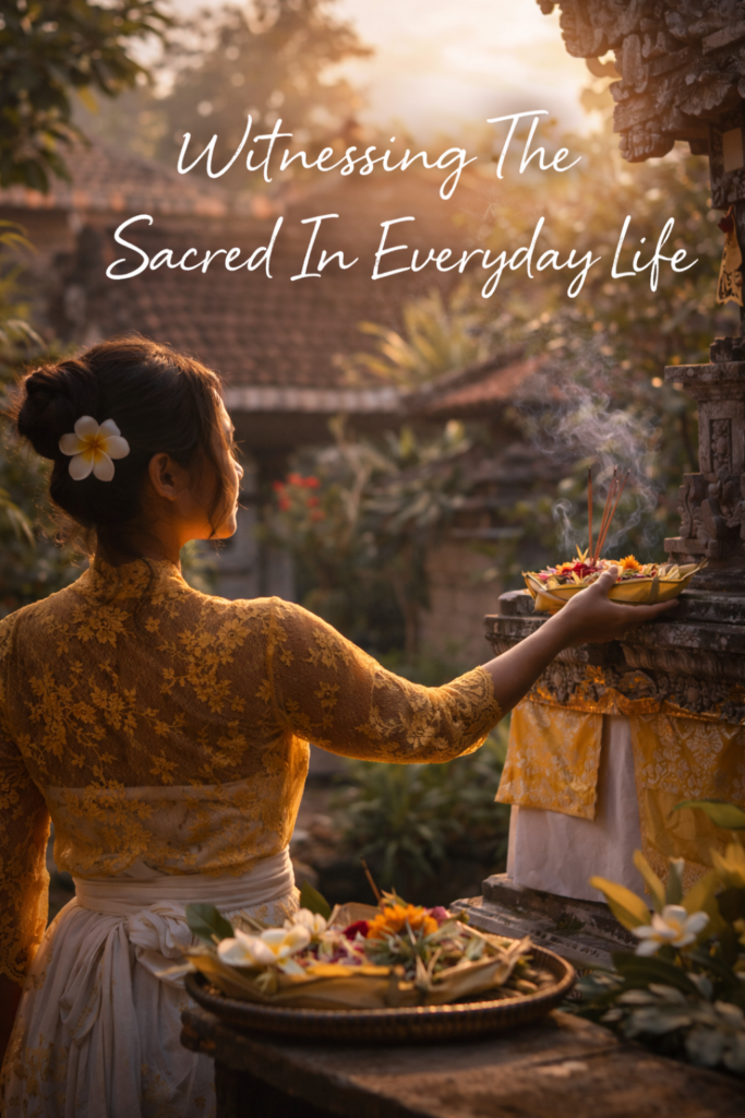 Balinese woman in a yellow lace kebaya offering flowers and incense at a temple shrine at sunrise, with smoke drifting upward and the words ‘Witnessing The Sacred In Everyday Life’ written above